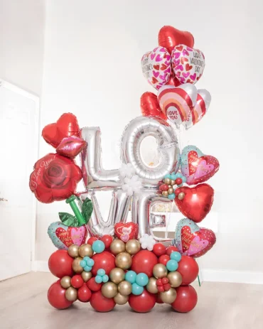 Oversized balloon bouquet with the word LOVE and a bunch of helium balloons, designed for romantic celebrations like anniversaries or proposals