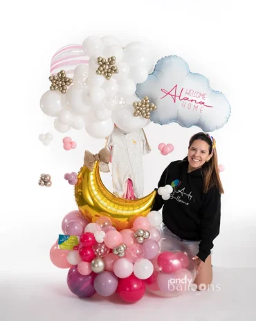 Dreamy baby balloon arrangement with a stand, featuring balloons and a baby onesie, perfect for a baby welcome celebration