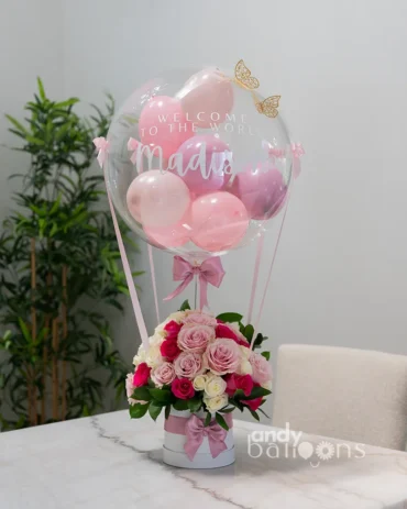 Baby welcome flower arrangement with bubble balloon and hot air balloon design, perfect for welcoming a newborn with same-day delivery