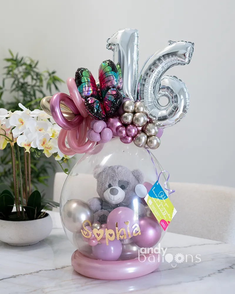 Stuffed balloon gift featuring a teddy bear plush inside and a balloon topper with the age, perfect for birthdays or special celebrations