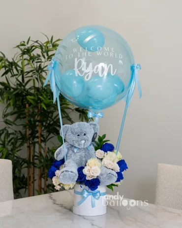 Flower arrangement with balloons and a teddy bear, ideal for welcoming a new baby at the hospital or home delivery