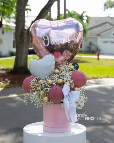 Pink baby’s breath flower arrangement with chocolate box in a romantic gift design