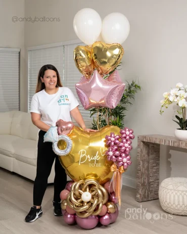 Gold and rose gold Bride to Be balloon display with a diamond ring accent.