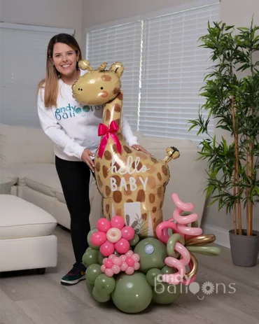 Large giraffe balloon arrangement, featuring pink flower balloons and green organic balloon base for a safari-themed gift.